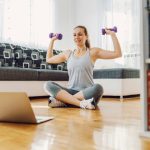 woman doing her work out routine from home living room
