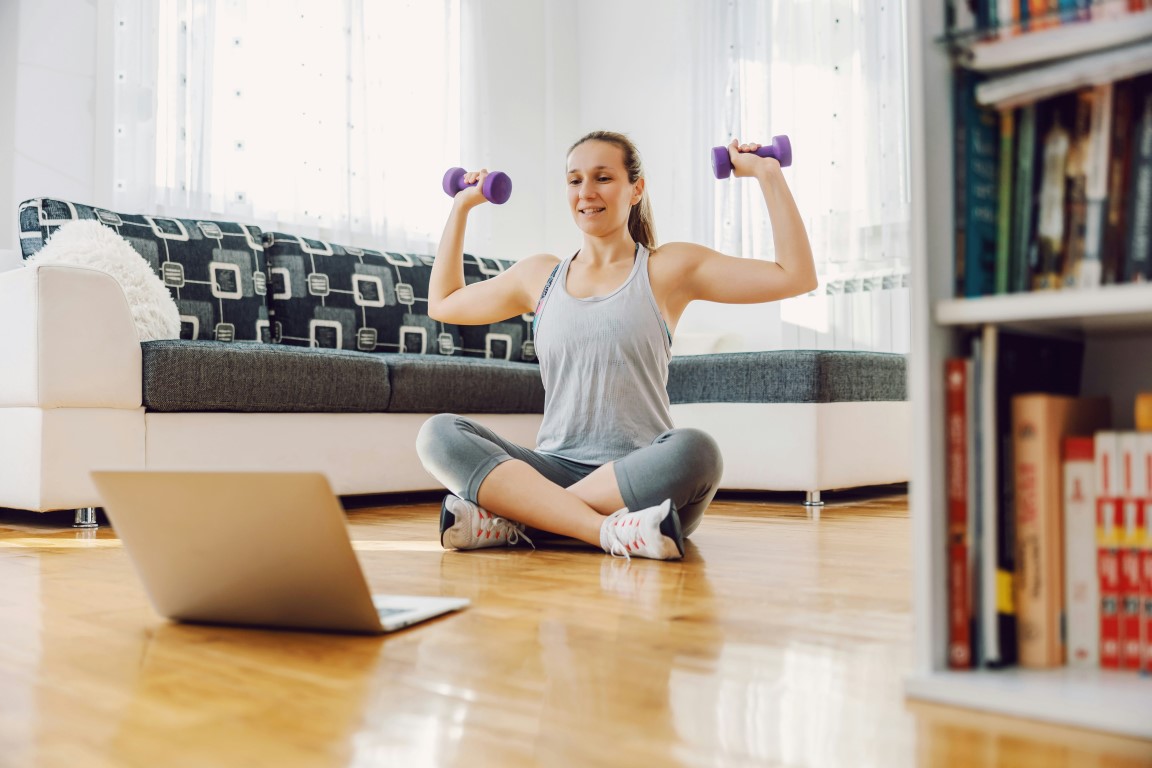 woman doing her work out routine from home living room